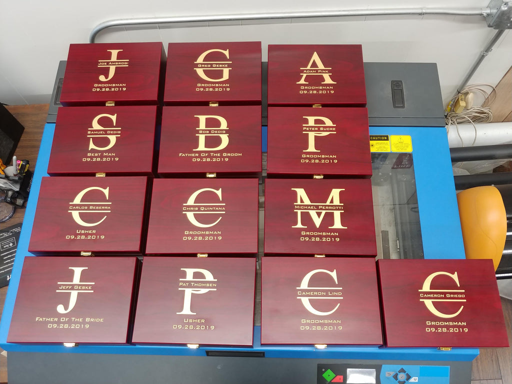 Custom engraved wooden groomsmen boxes with gold text for wedding party gifts