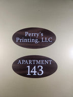 Oval wood grain apartment number and business door signs with white text on a gold background