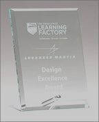 Clear glass plaque with engraved text for a design excellence award, upright on a stand.