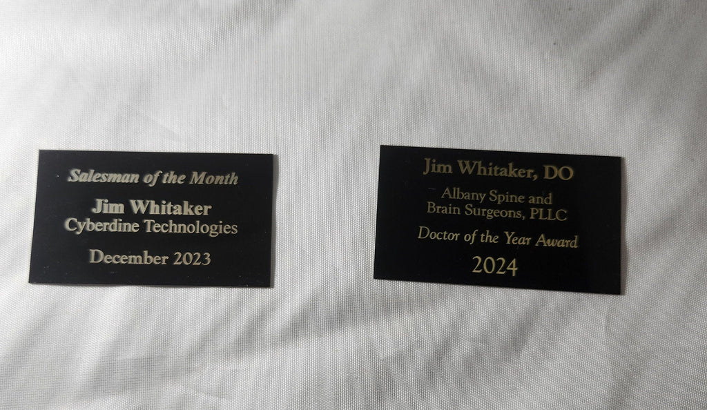 Custom laser engraved award plaques with gold text on black, for sales and professional achievements.