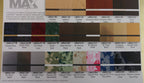 Laser engraving material color sample sheet with metallic, wood, camo, and patterned finishes.