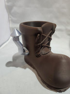 3D printed brown boot-shaped holder with a silver rocket detail
