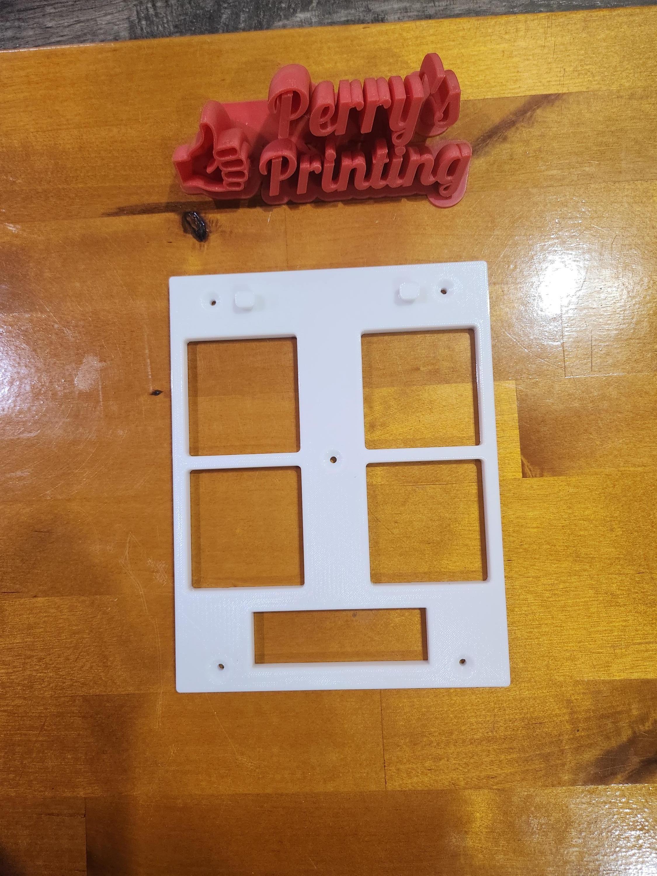 3D printed white mounting panel with rectangular cutouts on wood, with red Perry's Printing sign