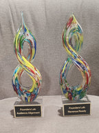 Multicolor helix art glass award with personalized engraving on a crystal base.