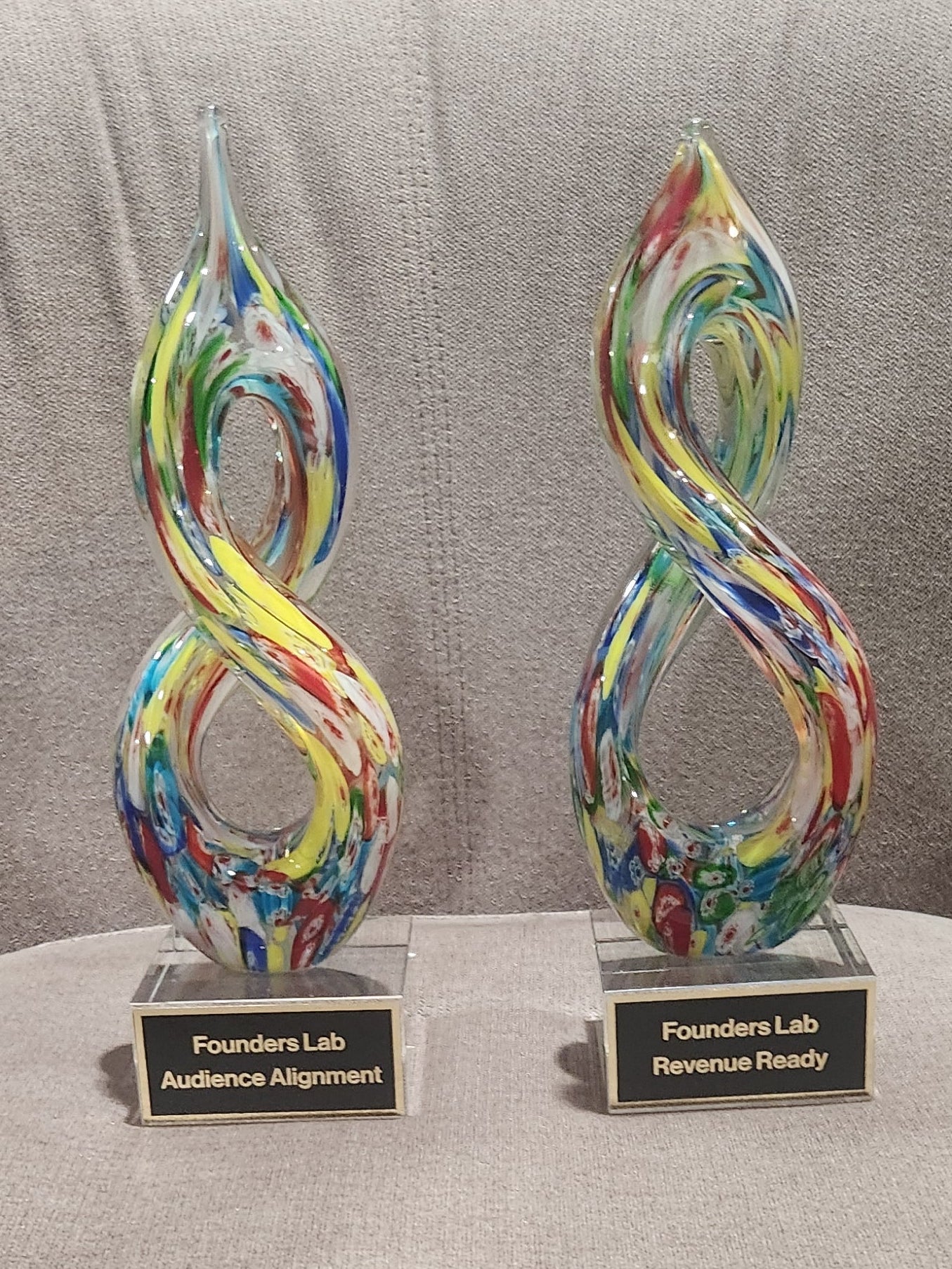 Multicolor helix art glass award with personalized engraving on a crystal base.