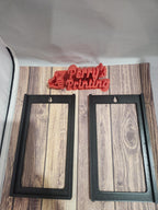 Two black 3D printed sign frames and a red Perry's Printing logo on wood background
