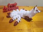 3D printed nine-tailed fox figurine with detailed markings on a wood surface