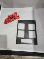 3D printed red sign with text and black plastic wall plate on a white background
