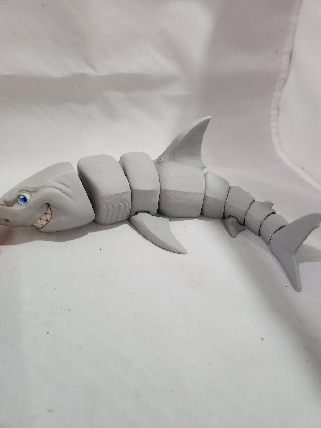 3D printed articulated shark toy with movable joints on a white background