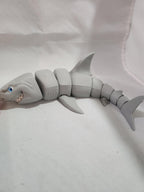 3D printed articulated shark toy with movable joints on a white background