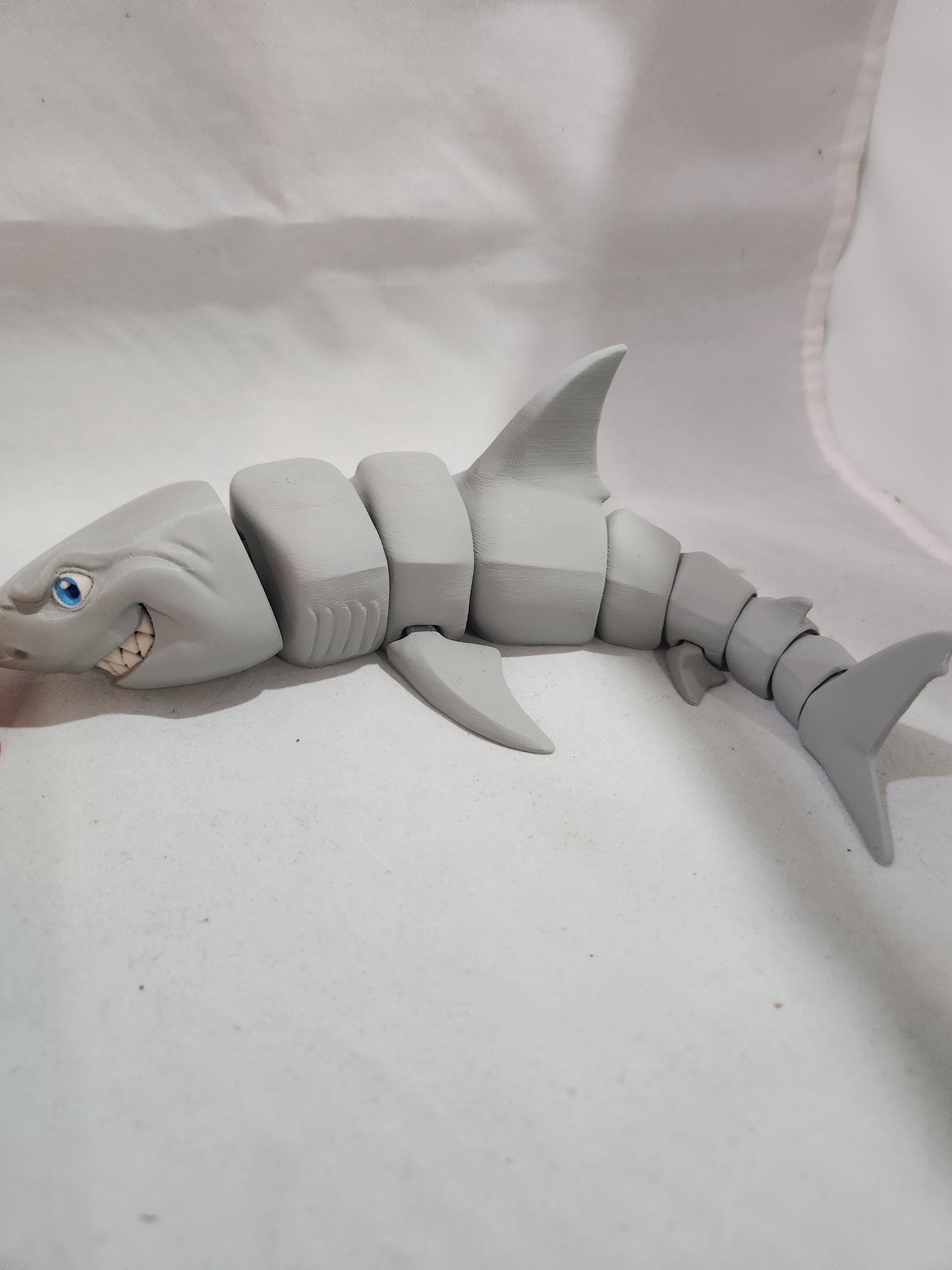 3D printed articulated shark toy with movable joints on a white background