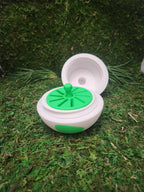 3D printed white and green container with lid, displayed on artificial grass