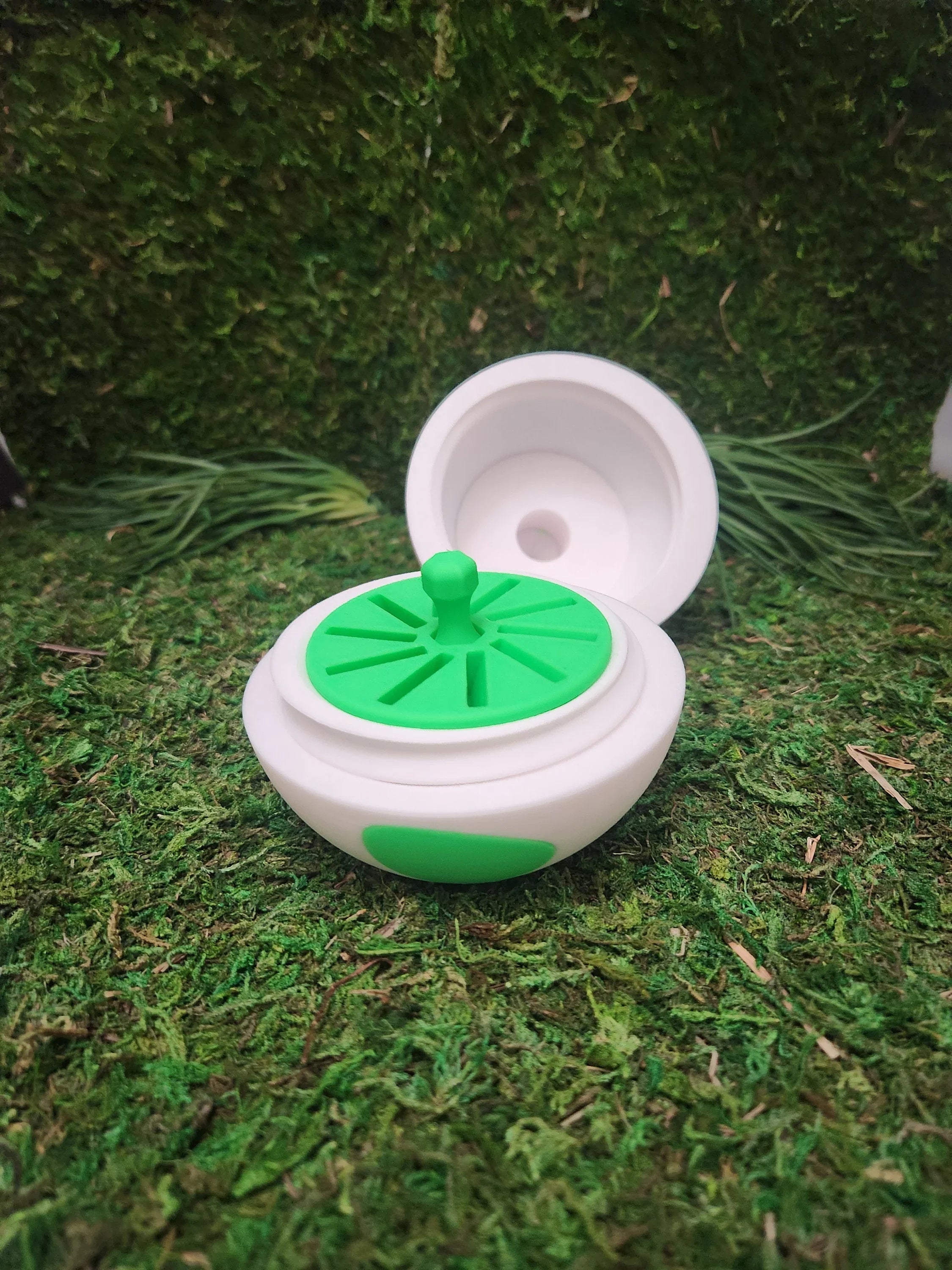 3D printed white and green container with lid, displayed on artificial grass