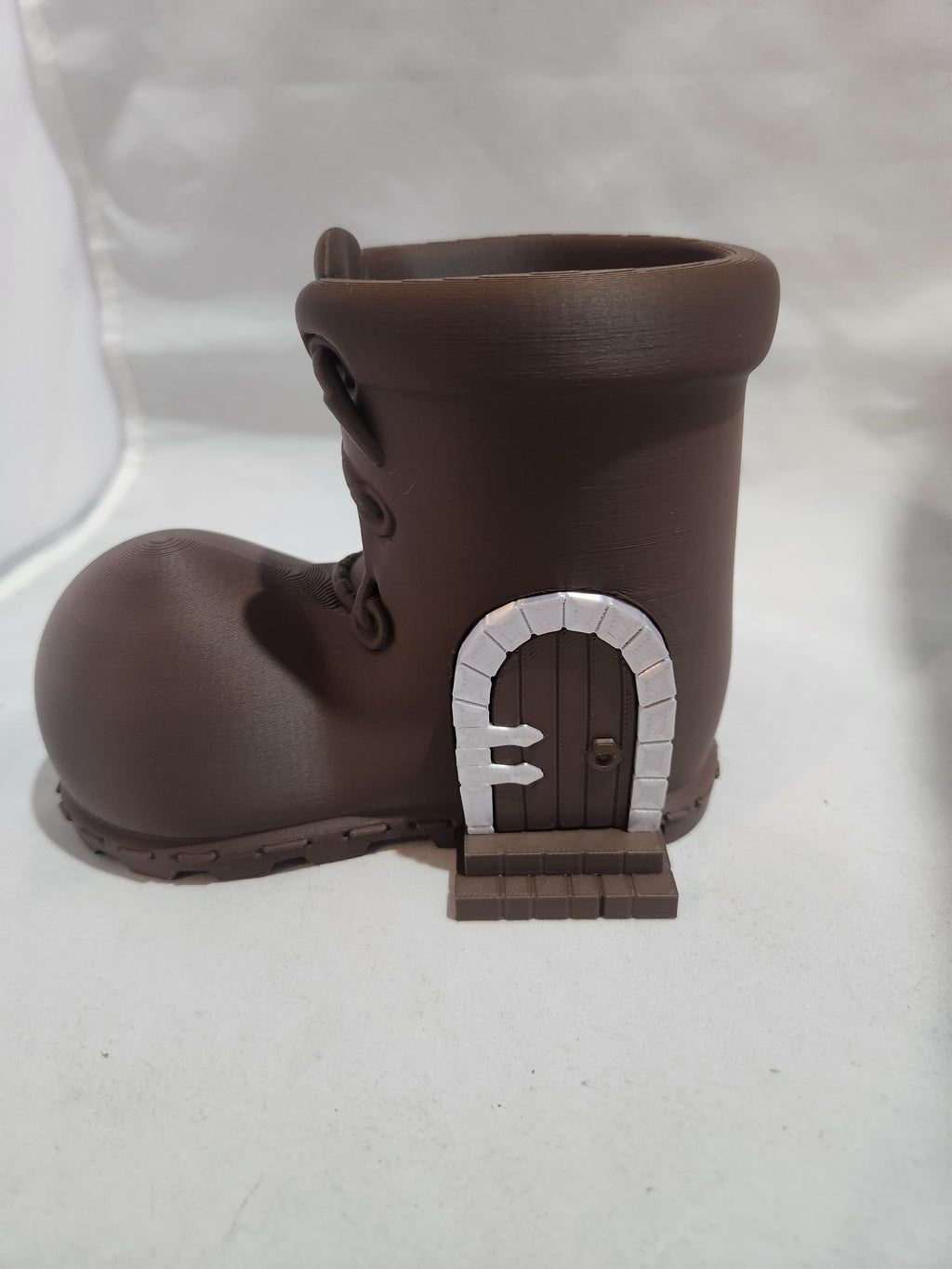 3D printed brown boot planter with a miniature door design, fantasy home decor