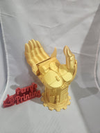 Gold 3D printed mechanical hand with red Perry's Printing sign on white backdrop