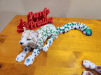 Articulated 3D printed leopard figurine with colorful patterns on a wooden table