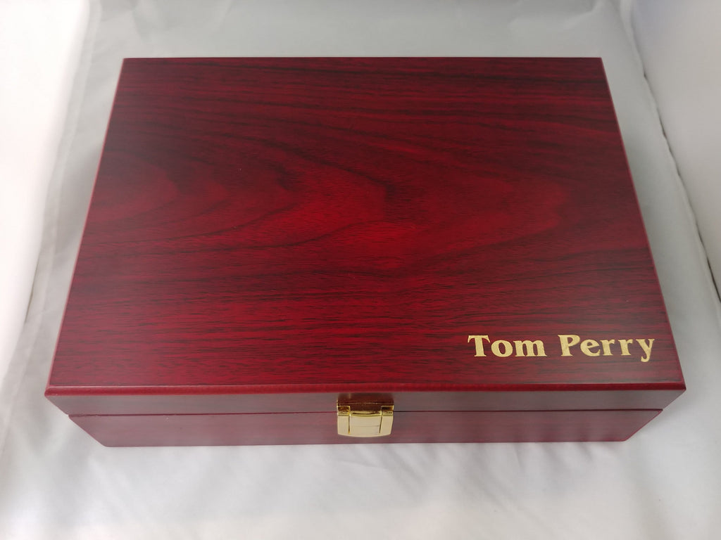Custom engraved polished wood box with gold lettering and clasp on white background