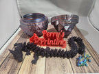 3D printed dragon, bowls, colorful lizard, and red Perry’s Printing sign on wood surface