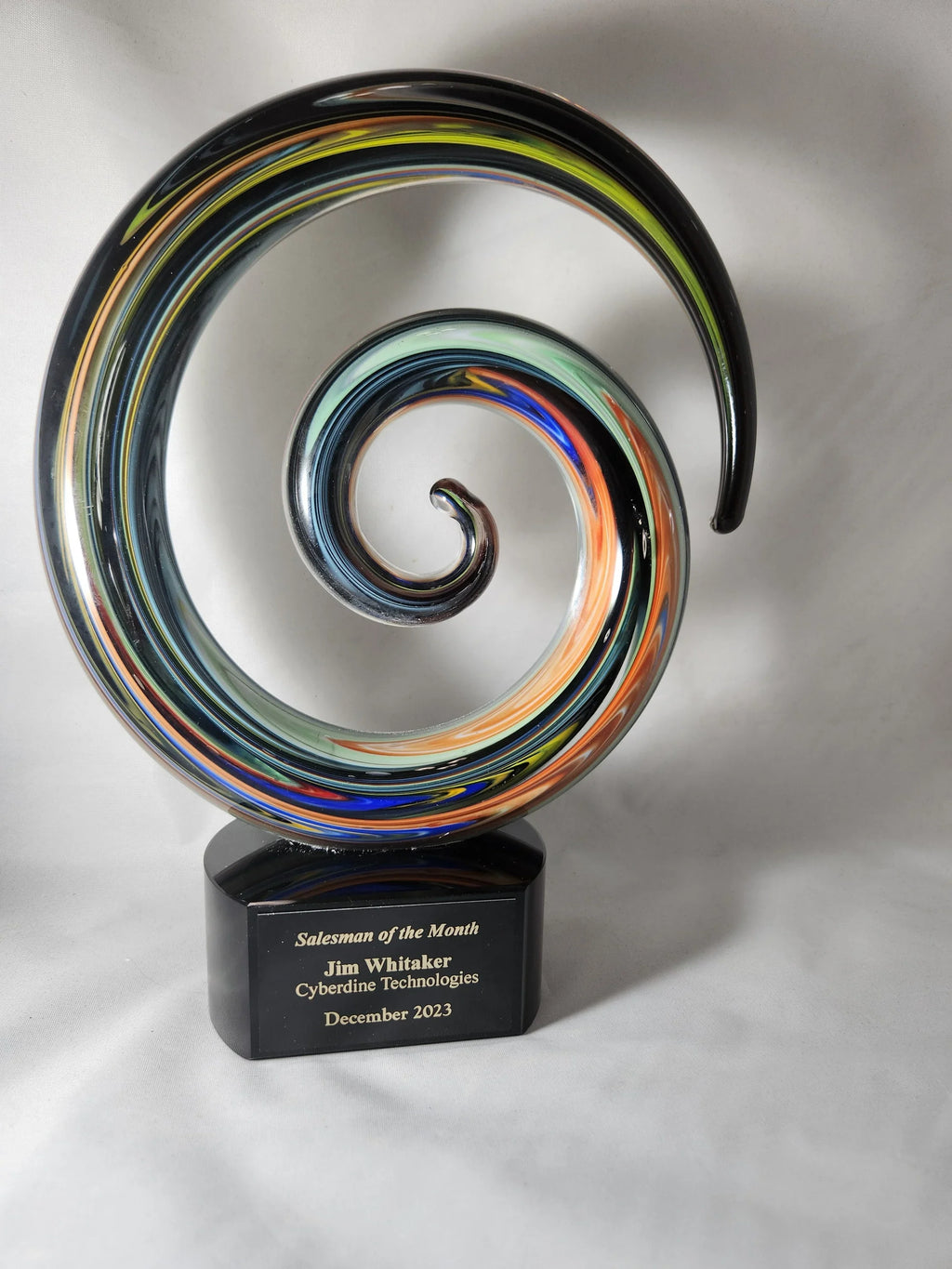 Colorful spiral glass award trophy with engraved plaque for salesman of the month