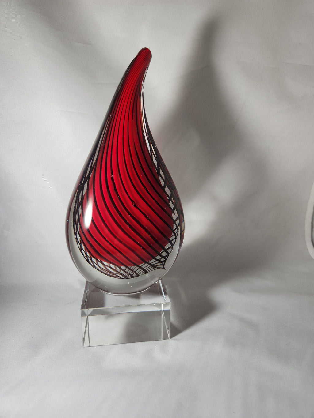Red and black striped glass award on clear acrylic base, ideal for custom recognition