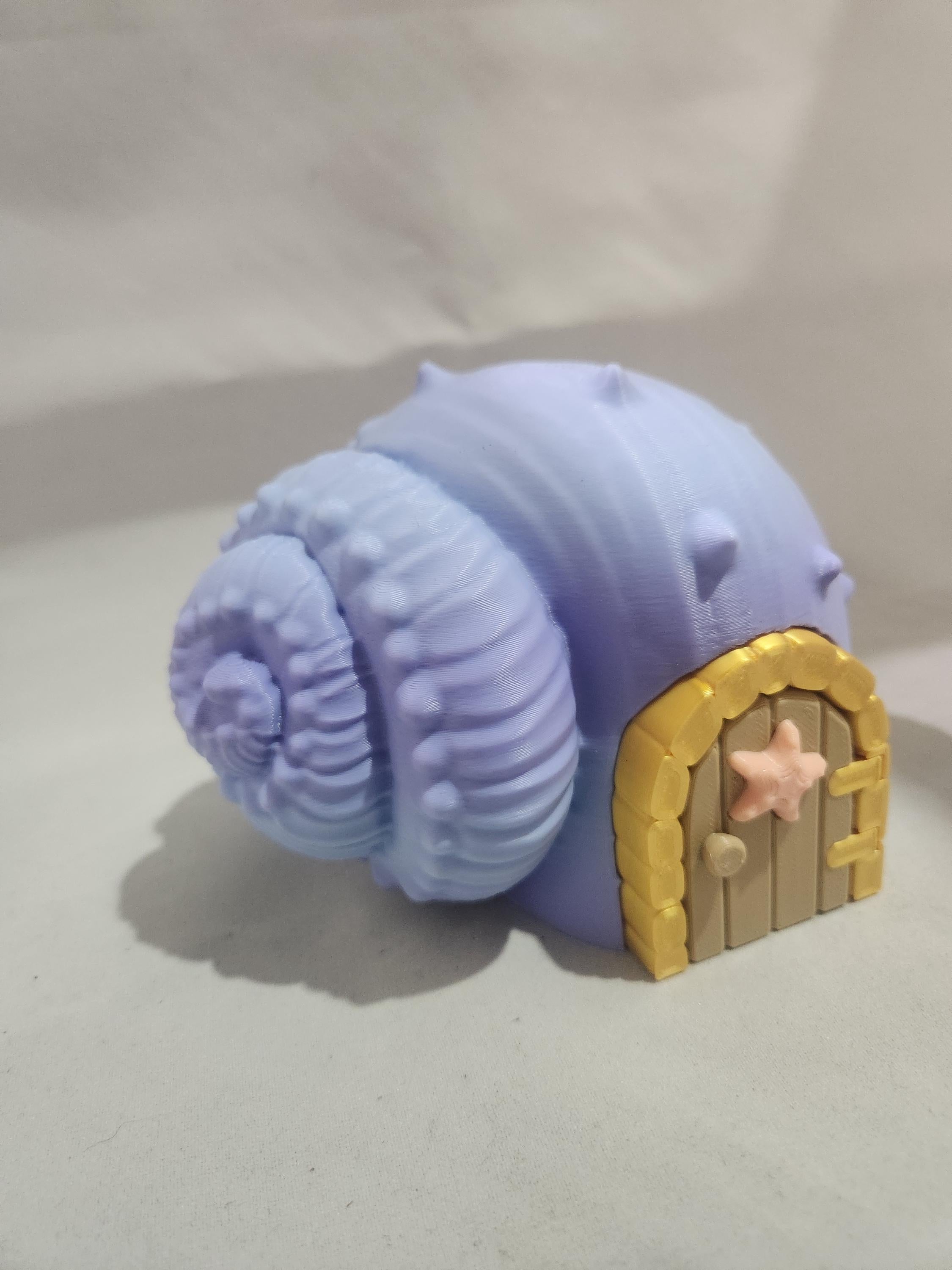 3D printed lavender seashell house with a yellow door and starfish detail