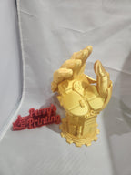 Yellow 3D printed robotic hand sculpture with Perry's Printing red logo sign on display table