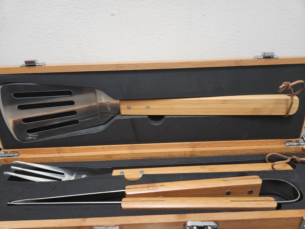 Bamboo handle BBQ grill tool set with spatula, tongs, and fork in a wooden storage case