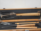 Bamboo handle BBQ grill tool set with spatula, tongs, and fork in a wooden storage case