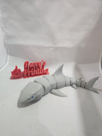 3D printed articulated shark figurine with red thumbs-up Perry's Printing sign