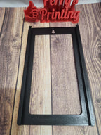 3D printed black rectangular frame for signage or engraving, displayed on wood surface