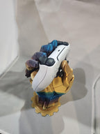 3D printed multicolor hand-shaped stand holding a white gaming controller on display