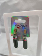 Handmade 3D printed green bottle earrings with gold hooks on holographic card display