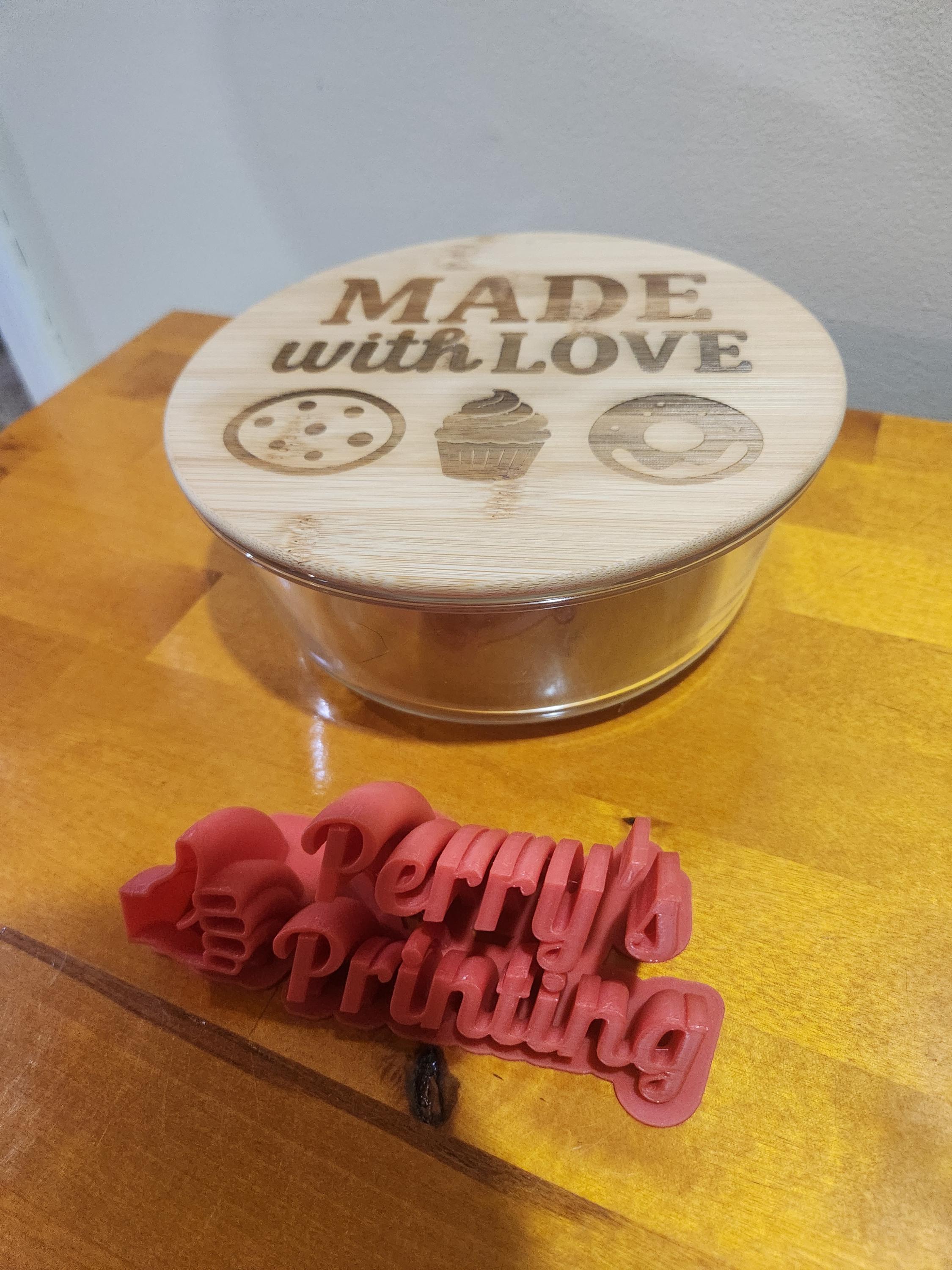 Laser engraved bamboo lid cookie jar with 'Made with Love' text and 3D printed red Perry's Printing sign.