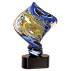 Decorative glass sculpture with blue and yellow swirls on a black base