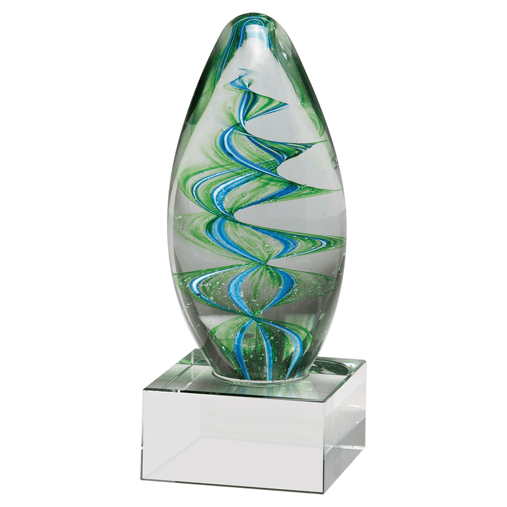 Decorative glass sculpture with green and blue swirls on a clear base against a white background