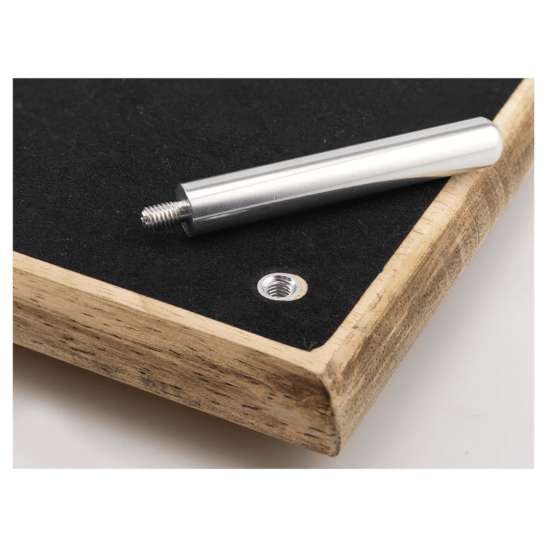 Metal rod with threaded end on a wooden surface