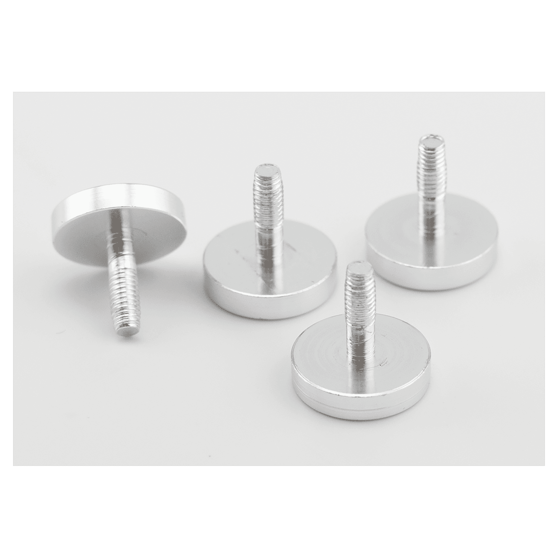 Set of metallic screws on a light gray background