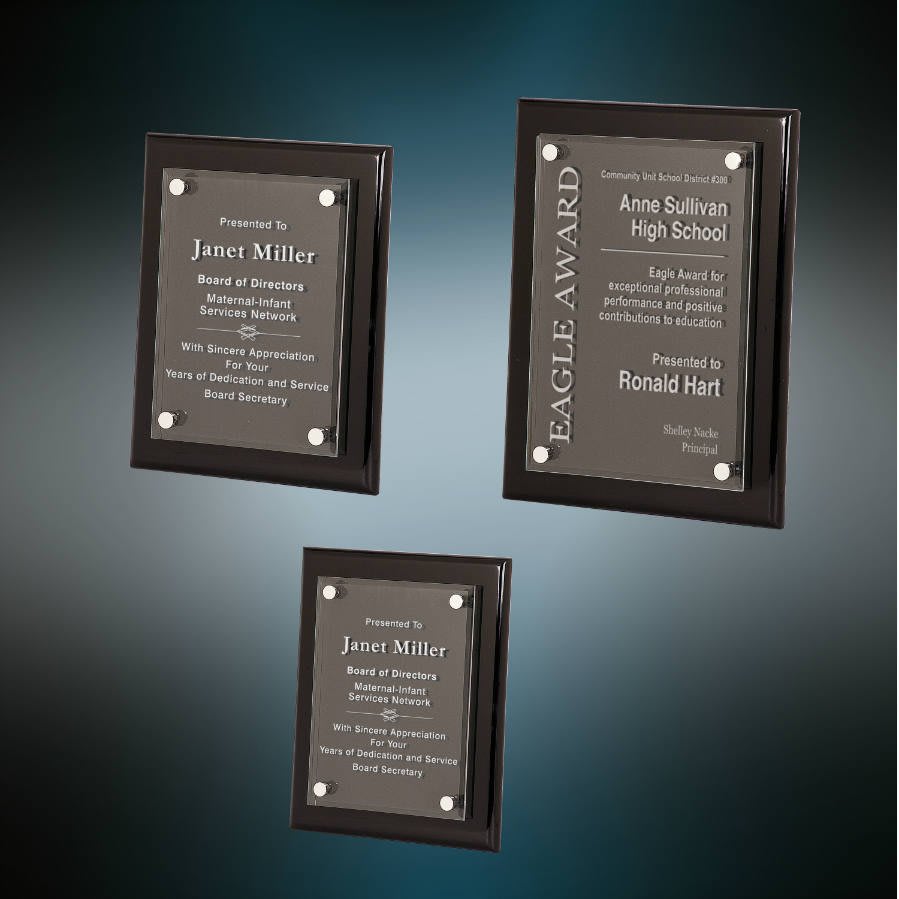 Three framed award plaques on a gradient blue background
