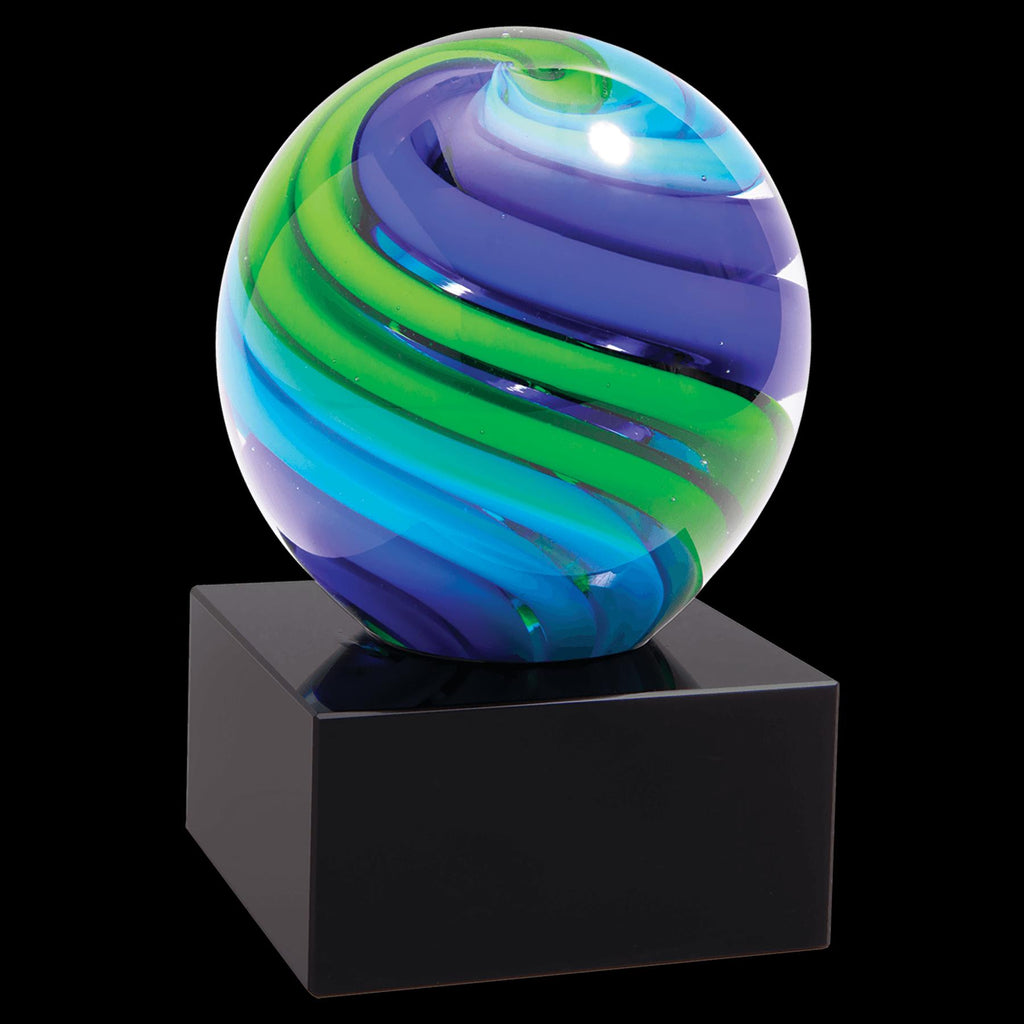 Colorful glass award with blue, green, and purple swirls on a black base, isolated on black