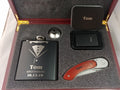 Personalized groomsman gift set with engraved flask, lighter, pocket knife, and metal tin in a wood box.