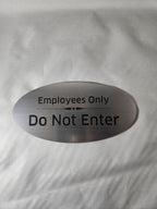 Brushed metal employees only do not enter sign with black engraved text