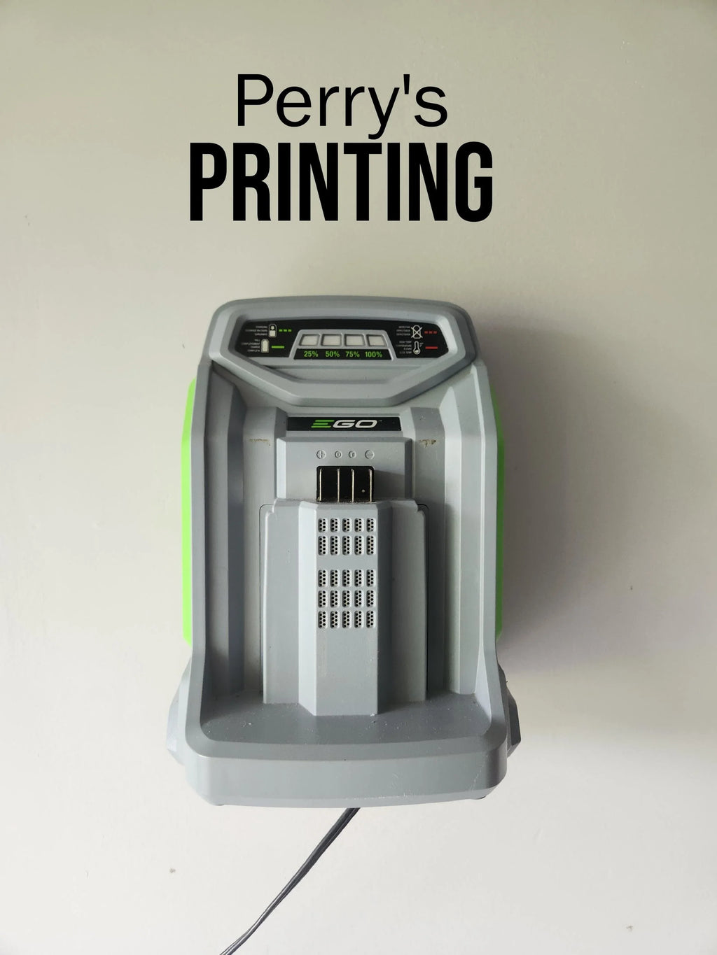 Wall-mounted battery charger below 'Perry's PRINTING' text on white background.