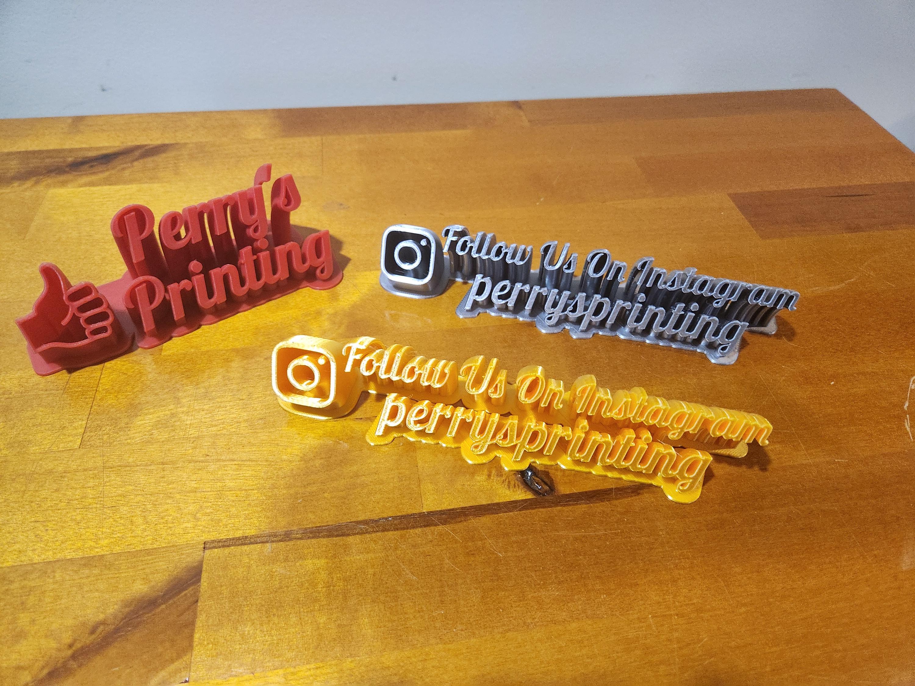 Custom 3D printed Instagram signs and Perry's Printing logo on wood table