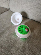 3D printed green and white storage container for Nintendo Switch game cards on a beige couch