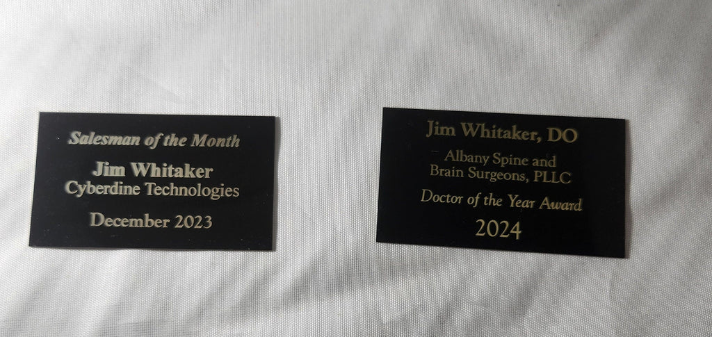 Custom engraved award plaques with gold text recognizing achievements, ideal for events and businesses