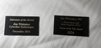 Custom engraved award plaques with gold text recognizing achievements, ideal for events and businesses