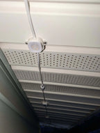 Outdoor soffit with installed LED puck lights and visible wiring for exterior lighting