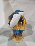 Colorful 3D printed hand-shaped controller stand holding a white game controller on a light background.