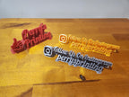 3D printed Instagram signs and a red Perry's Printing thumbs-up sign on wood table