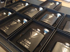 Custom engraved groomsman flasks with tuxedo design and names in gift boxes